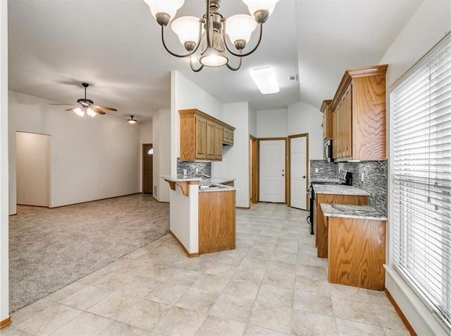4601 Churchill, Shawnee, OK 74804 - kitchen with black electric range, a peninsula, backsplash, a ceiling fan, and open floor plan