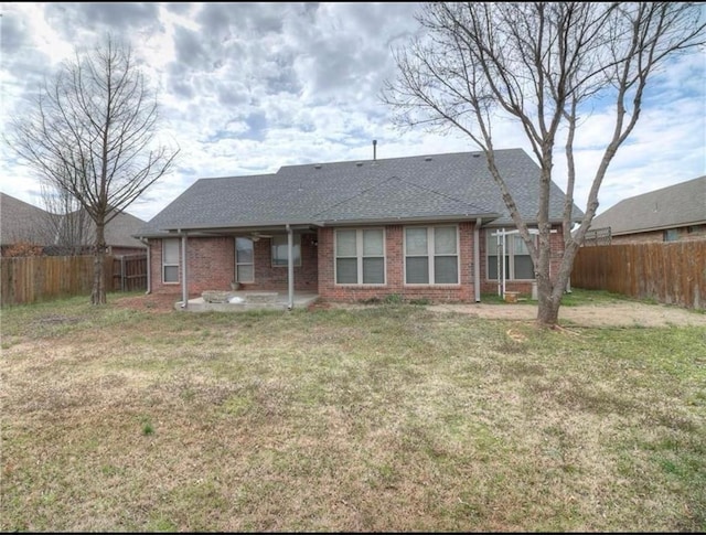4601 Churchill, Shawnee, OK 74804 - rear view of property featuring a fenced backyard, a patio area, brick siding, and a shingled roof