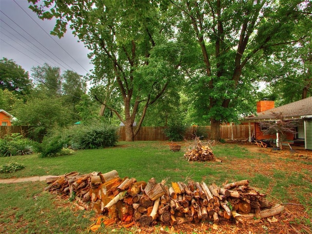 1213 Leslie Ln, Norman, OK 73069 - fenced backyard with an outdoor fire pit
