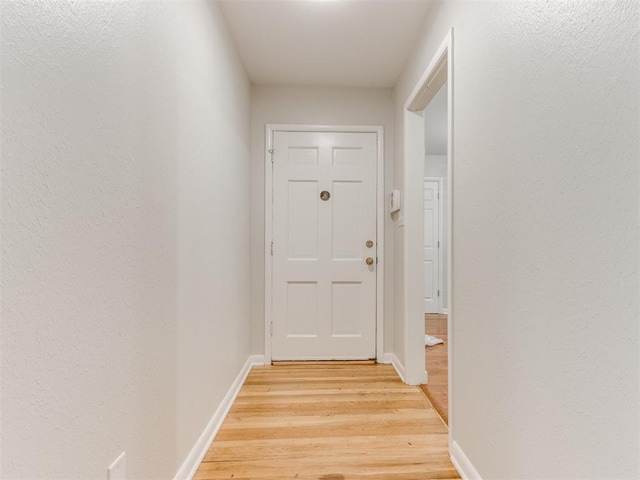 1213 Leslie Ln, Norman, OK 73069 - doorway with light wood-style flooring and baseboards
