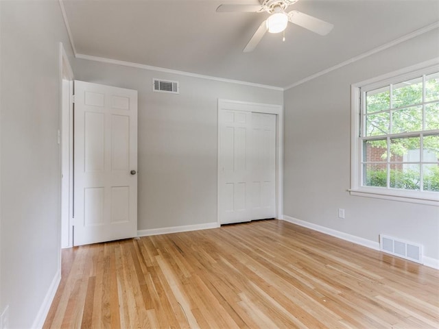1213 Leslie Ln, Norman, OK 73069 - unfurnished bedroom featuring light wood-style flooring, a closet, crown molding, and a ceiling fan