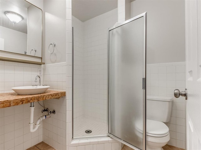 1213 Leslie Ln, Norman, OK 73069 - bathroom with tile walls, a shower stall, and wainscoting
