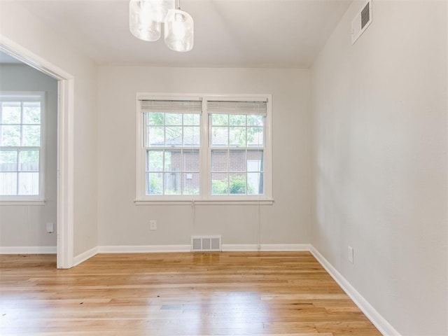 1213 Leslie Ln, Norman, OK 73069 - spare room featuring light wood-type flooring and a chandelier