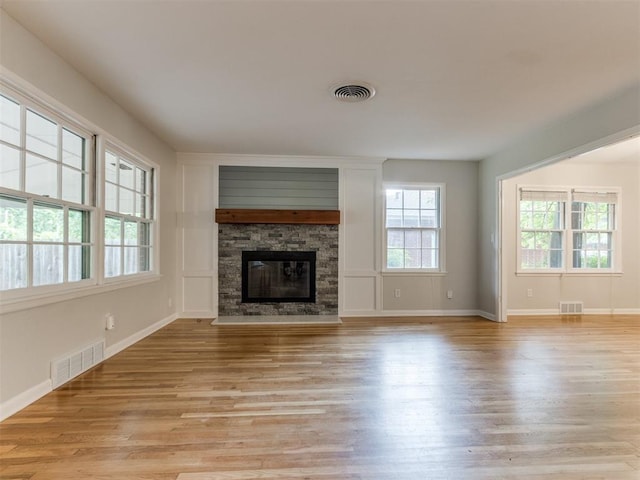 1213 Leslie Ln, Norman, OK 73069 - unfurnished living room featuring light wood-type flooring and a fireplace