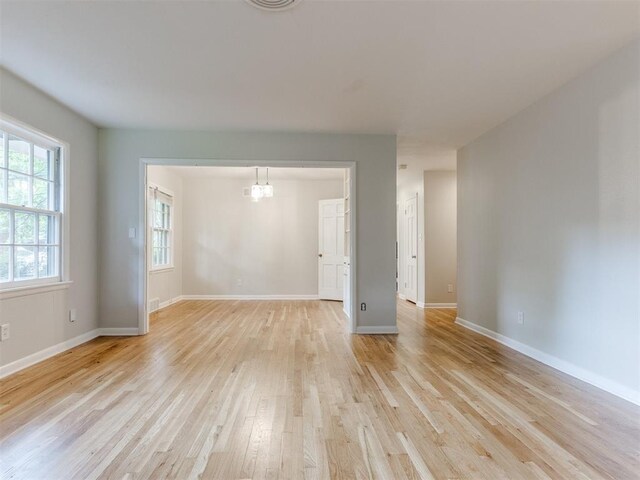 1213 Leslie Ln, Norman, OK 73069 - unfurnished room featuring light wood finished floors and a chandelier