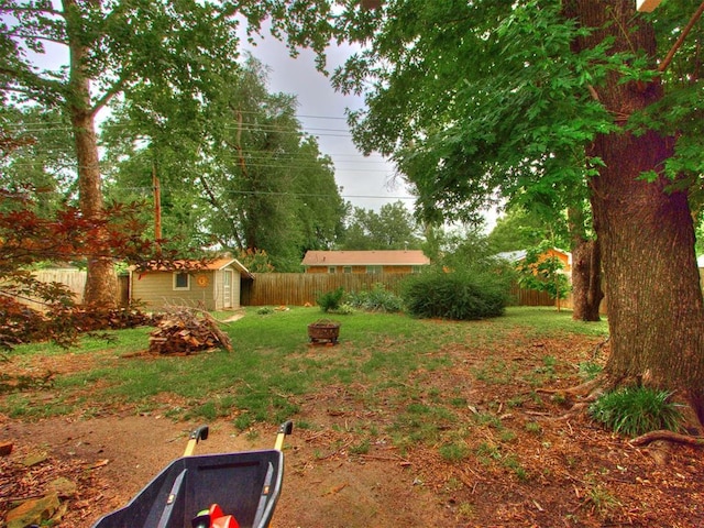 1213 Leslie Ln, Norman, OK 73069 - fenced backyard with a storage unit and an outdoor fire pit