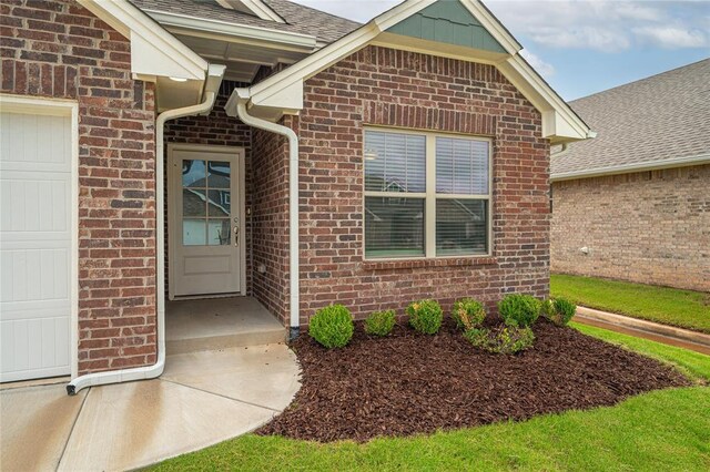 3808 Palmetto Trl, Oklahoma City, OK 73179 - entrance to property featuring brick siding, a shingled roof, and a garage