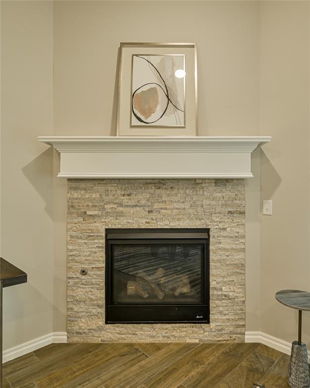 3808 Palmetto Trl, Oklahoma City, OK 73179 - detailed view of wood finished floors and a stone fireplace