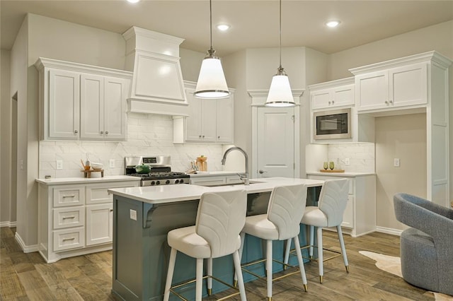 3808 Palmetto Trl, Oklahoma City, OK 73179 - kitchen with stainless steel stove, built in microwave, custom range hood, light countertops, and white cabinets