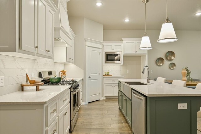 3808 Palmetto Trl, Oklahoma City, OK 73179 - kitchen featuring appliances with stainless steel finishes, custom exhaust hood, backsplash, white cabinets, and light wood-style floors