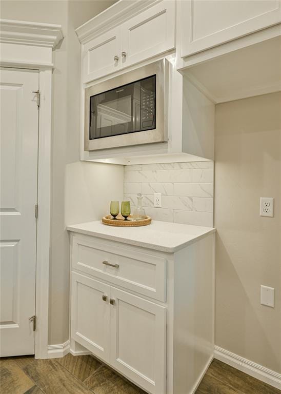3808 Palmetto Trl, Oklahoma City, OK 73179 - kitchen featuring built in microwave, tasteful backsplash, light countertops, and white cabinetry