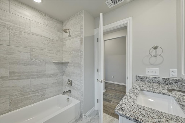 3808 Palmetto Trl, Oklahoma City, OK 73179 - bathroom featuring shower / bath combination, double vanity, and wood finished floors