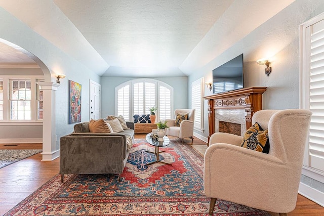 416 W Hill St, Oklahoma City, OK 73118 - living area featuring arched walkways, wood finished floors, and a premium fireplace