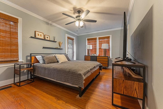 416 W Hill St, Oklahoma City, OK 73118 - bedroom featuring wood finished floors, crown molding, and a ceiling fan