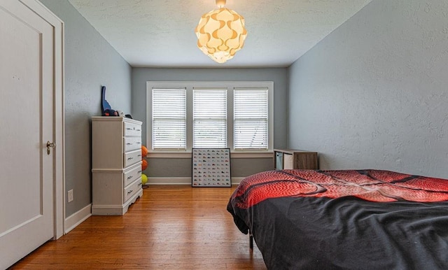 416 W Hill St, Oklahoma City, OK 73118 - bedroom with wood-type flooring and a textured wall