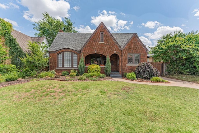 416 W Hill St, Oklahoma City, OK 73118 - english style home featuring brick siding and covered porch