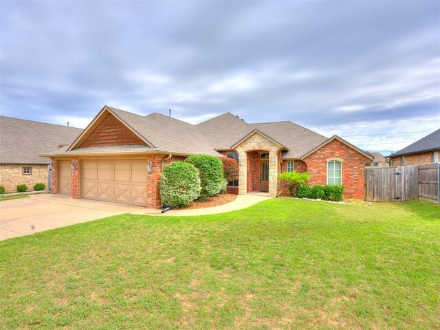 2801 SE 5th St, Moore, OK 73160 - view of front of house featuring a garage, concrete driveway, brick siding, and a shingled roof