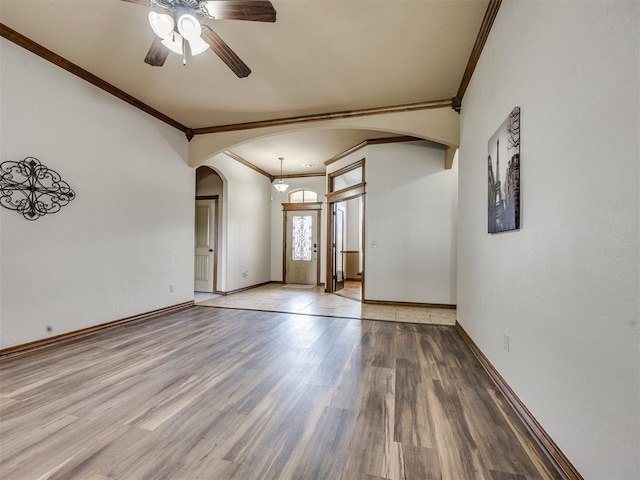 2801 SE 5th St, Moore, OK 73160 - spare room with arched walkways, crown molding, ceiling fan, and wood finished floors