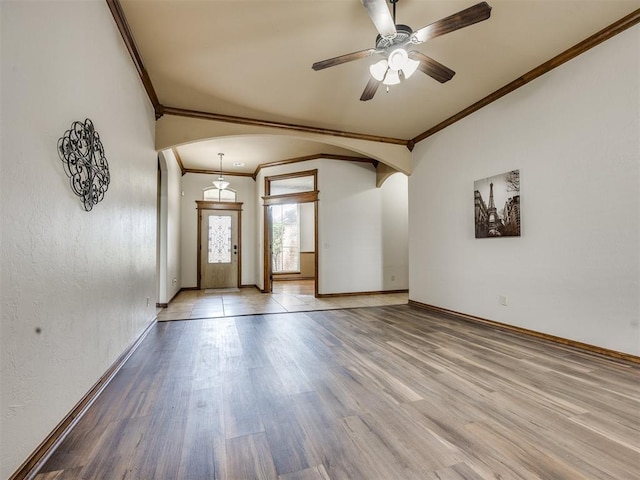 2801 SE 5th St, Moore, OK 73160 - unfurnished room featuring arched walkways, crown molding, wood finished floors, and ceiling fan