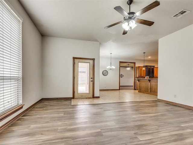 2801 SE 5th St, Moore, OK 73160 - unfurnished living room with plenty of natural light, light wood-style floors, and ceiling fan