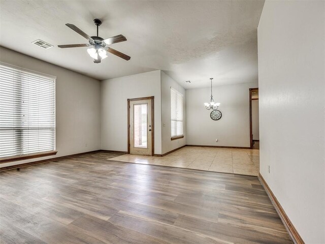 2801 SE 5th St, Moore, OK 73160 - unfurnished room featuring ceiling fan, a chandelier, and light wood-type flooring