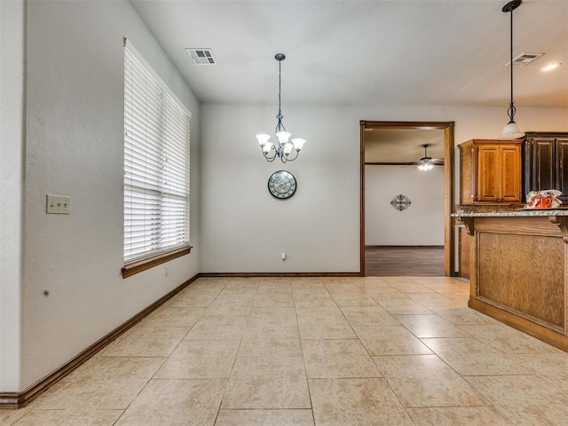 2801 SE 5th St, Moore, OK 73160 - unfurnished dining area featuring light tile patterned floors, a chandelier, and ceiling fan