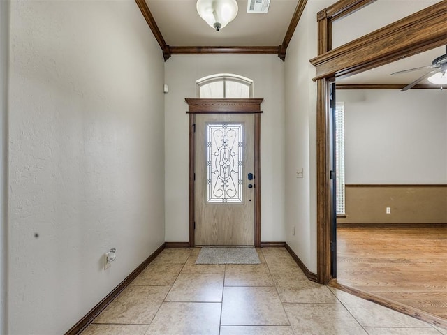 2801 SE 5th St, Moore, OK 73160 - foyer entrance featuring ornamental molding, plenty of natural light, a ceiling fan, and light tile patterned floors