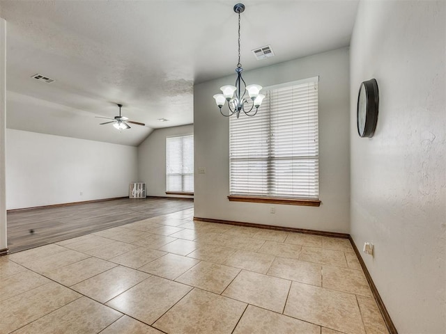 2801 SE 5th St, Moore, OK 73160 - unfurnished room with light tile patterned flooring, a ceiling fan, vaulted ceiling, and a chandelier