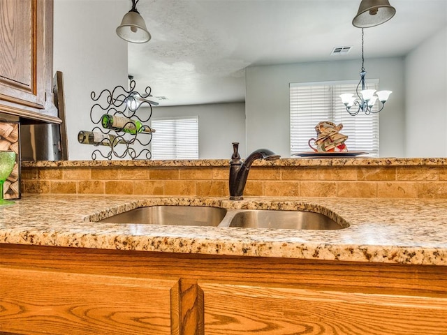 2801 SE 5th St, Moore, OK 73160 - kitchen view of decorative light fixtures, a chandelier, and light stone countertops
