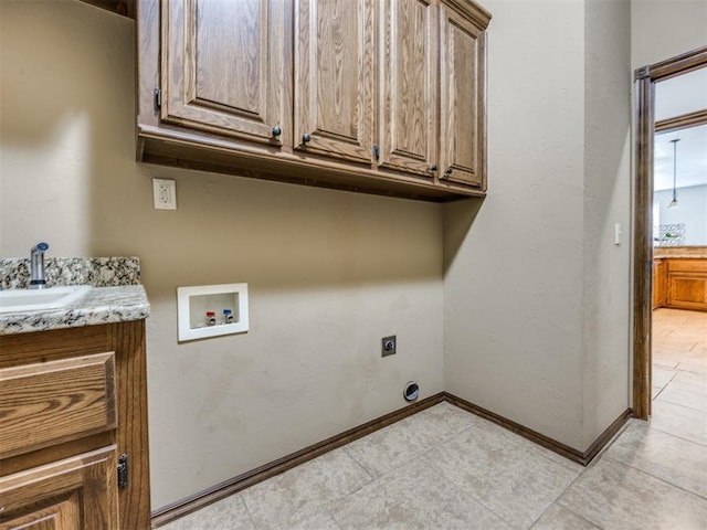 2801 SE 5th St, Moore, OK 73160 - laundry area featuring cabinet space, washer hookup, electric dryer hookup, and light tile patterned floors