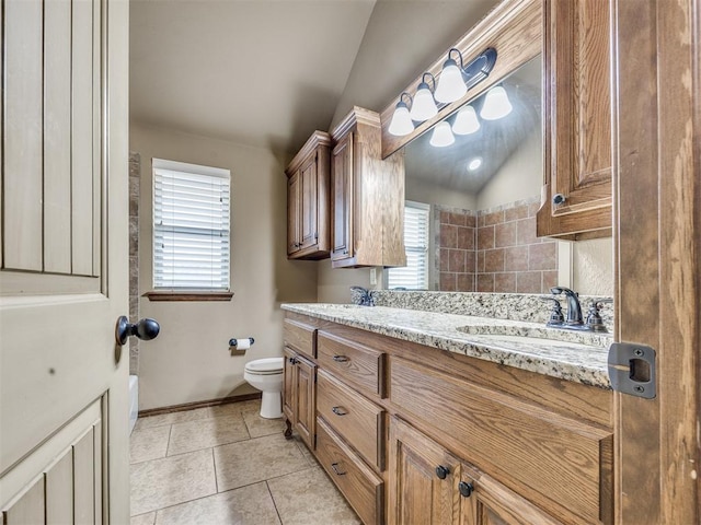 2801 SE 5th St, Moore, OK 73160 - bathroom with double vanity, tile patterned floors, and vaulted ceiling