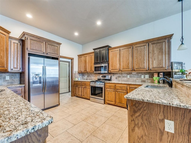 2801 SE 5th St, Moore, OK 73160 - kitchen featuring stainless steel appliances, tasteful backsplash, brown cabinets, light tile patterned flooring, and recessed lighting