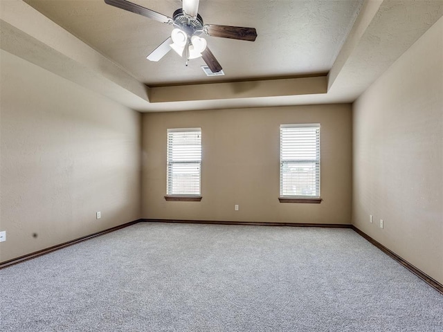 2801 SE 5th St, Moore, OK 73160 - carpeted empty room with a raised ceiling and ceiling fan