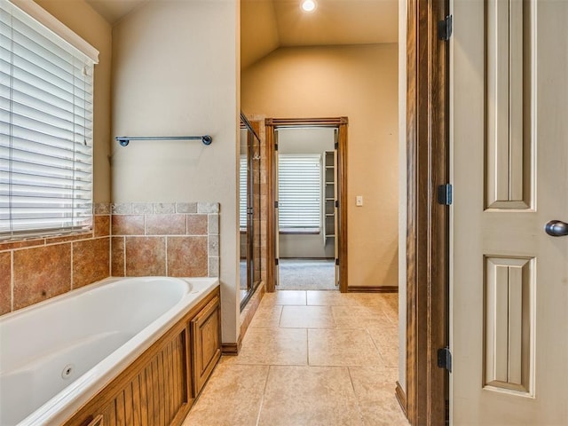 2801 SE 5th St, Moore, OK 73160 - bathroom with a whirlpool tub, tile patterned flooring, a stall shower, and lofted ceiling