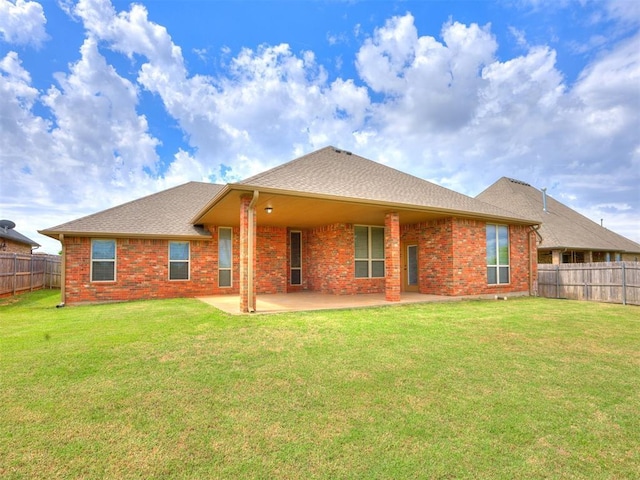 2801 SE 5th St, Moore, OK 73160 - rear view of house featuring a fenced backyard, a patio, brick siding, and a shingled roof