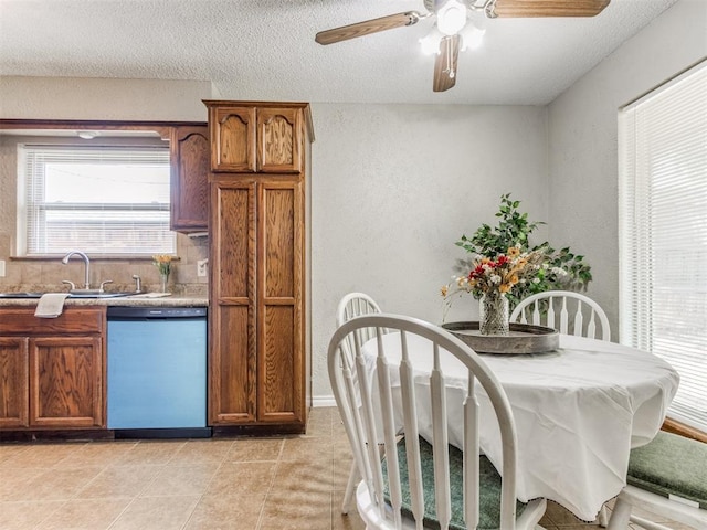 12501 SW 6th St, Yukon, OK 73099 - dining area with a textured wall, ceiling fan, a textured ceiling, and light tile patterned floors