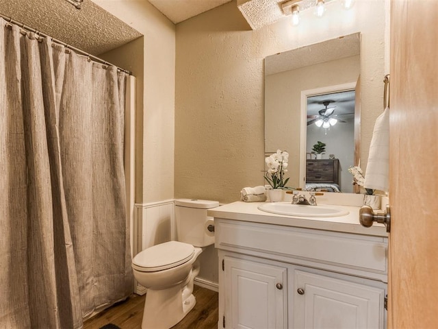 12501 SW 6th St, Yukon, OK 73099 - full bath featuring a textured wall, vanity, wood finished floors, and a shower with curtain