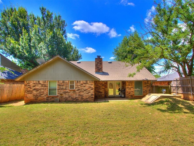 12501 SW 6th St, Yukon, OK 73099 - rear view of property with brick siding, a fenced backyard, and a chimney