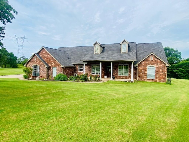450 Hickory Hill Dr, Choctaw, OK 73020 - new england style home featuring a front yard, roof with shingles, and brick siding