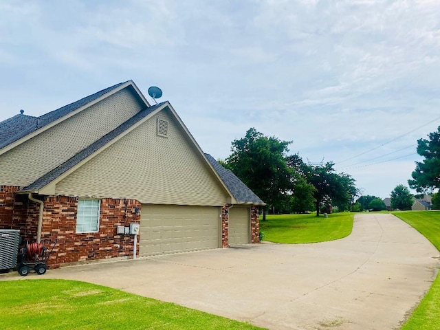 450 Hickory Hill Dr, Choctaw, OK 73020 - view of home's exterior featuring a yard, a garage, brick siding, and driveway