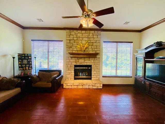 450 Hickory Hill Dr, Choctaw, OK 73020 - living area featuring a stone fireplace, a ceiling fan, and crown molding