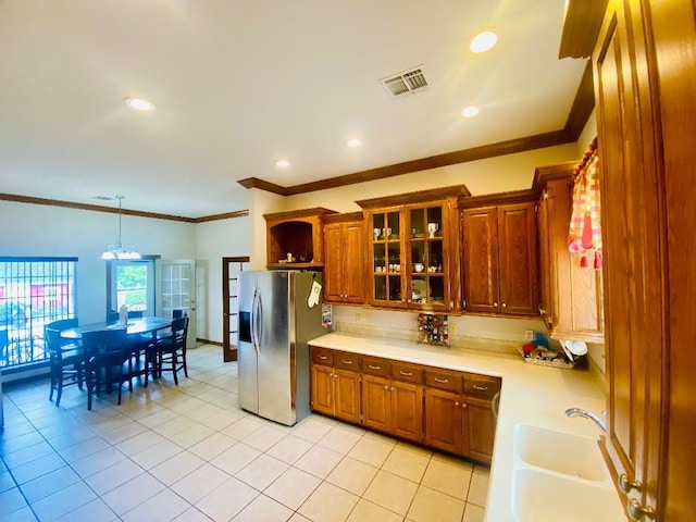 450 Hickory Hill Dr, Choctaw, OK 73020 - kitchen with stainless steel fridge with ice dispenser, light countertops, brown cabinets, ornamental molding, and glass insert cabinets