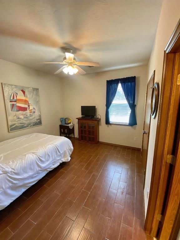 450 Hickory Hill Dr, Choctaw, OK 73020 - bedroom with dark wood-type flooring and ceiling fan