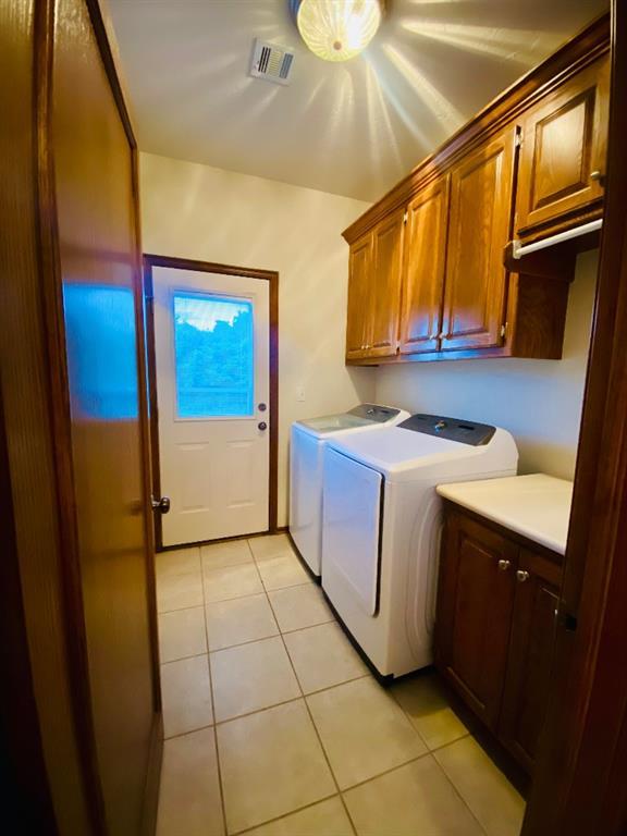 450 Hickory Hill Dr, Choctaw, OK 73020 - washroom featuring cabinet space, separate washer and dryer, and light tile patterned flooring