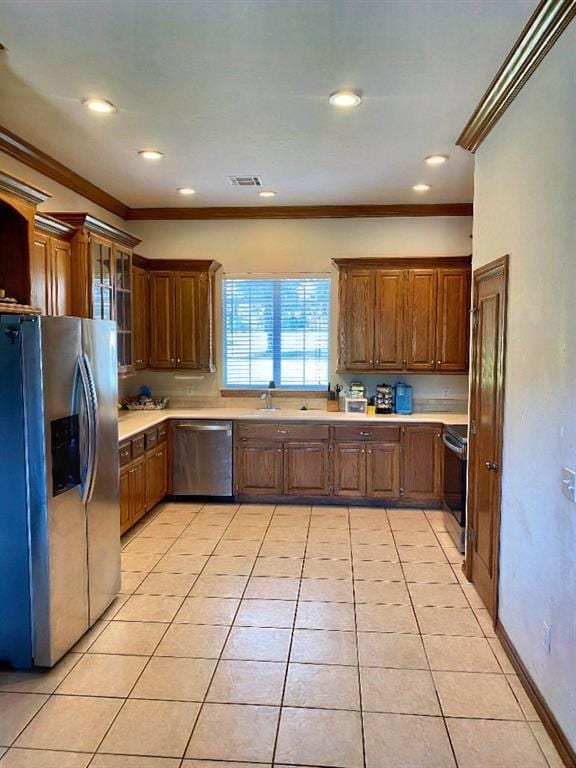 450 Hickory Hill Dr, Choctaw, OK 73020 - kitchen featuring appliances with stainless steel finishes, crown molding, light countertops, light tile patterned floors, and glass insert cabinets