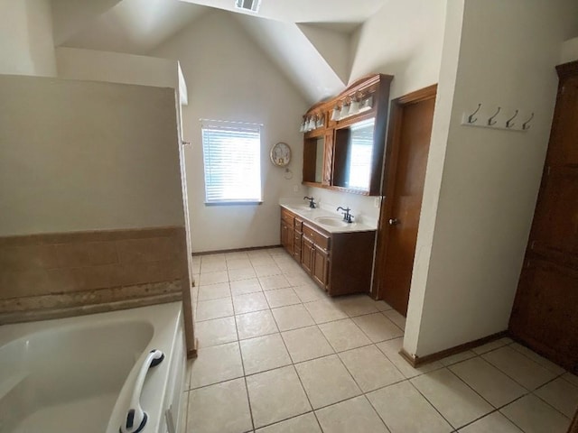 450 Hickory Hill Dr, Choctaw, OK 73020 - full bath featuring a garden tub, tile patterned floors, double vanity, and vaulted ceiling
