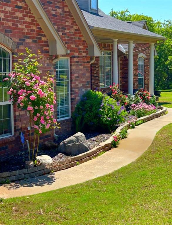 450 Hickory Hill Dr, Choctaw, OK 73020 - view of exterior entry with a yard and brick siding
