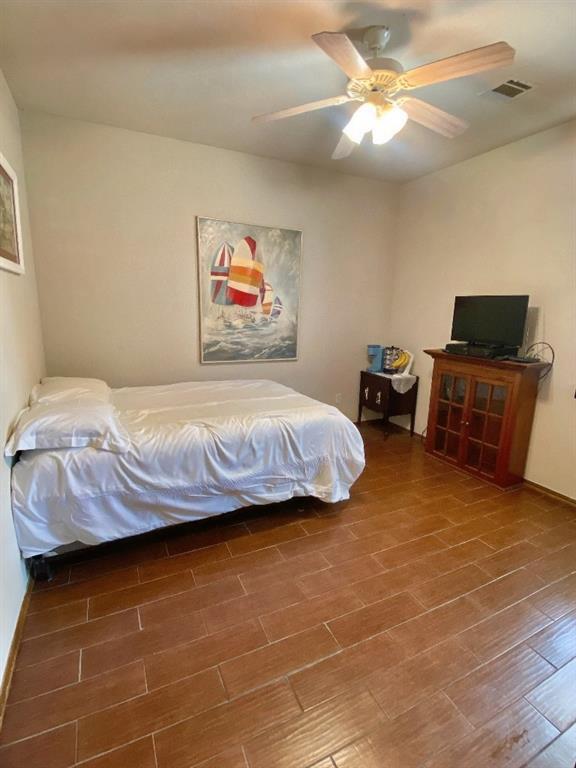 450 Hickory Hill Dr, Choctaw, OK 73020 - bedroom with wood finished floors and a ceiling fan
