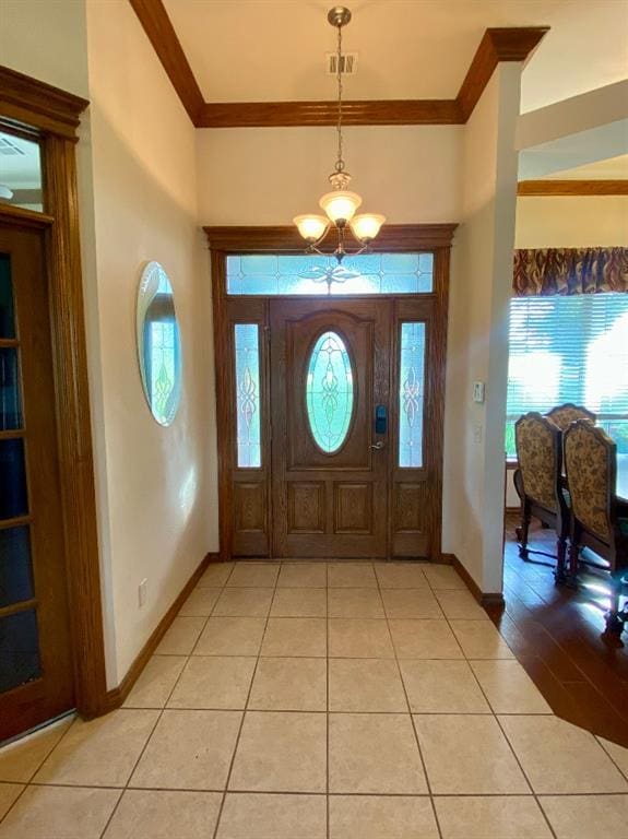 450 Hickory Hill Dr, Choctaw, OK 73020 - entrance foyer featuring crown molding, healthy amount of natural light, a chandelier, and light tile patterned floors