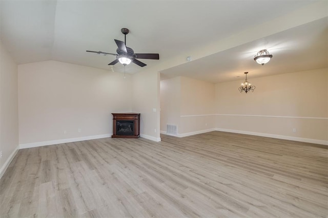 12210 High Meadow Ct, Oklahoma City, OK 73170 - unfurnished living room with a chandelier, light wood-style flooring, ceiling fan, and vaulted ceiling